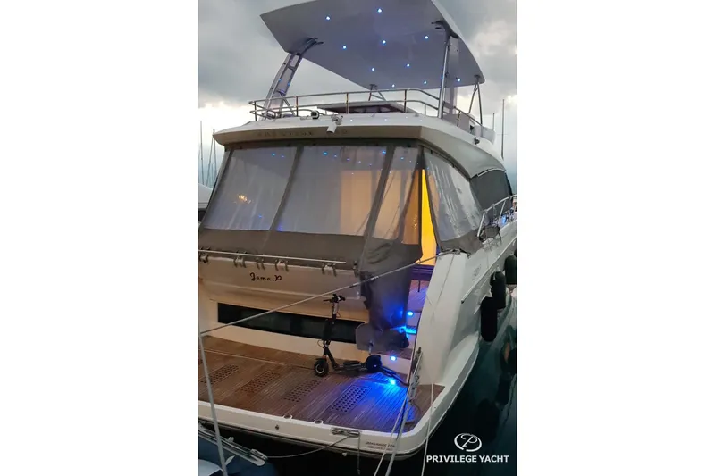  Yacht Photos Pics Luxury 2016 Prestige 550 yacht with illuminated deck and canopy at marina.