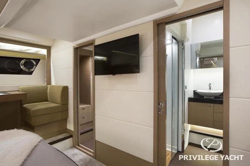  Yacht Photos Pics Luxurious interior of 2016 Prestige 550 yacht with modern bathroom and seating area.