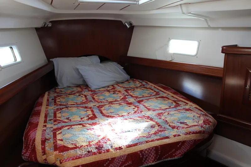 Coyote Yacht Photos Pics Cozy cabin interior of 2004 Beneteau Oceanis Clipper 423 with colorful quilted bedspread.