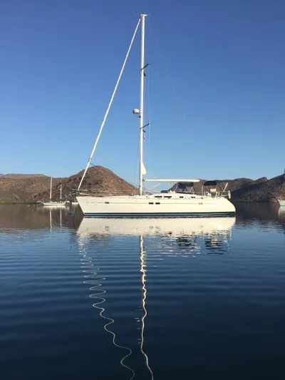 Coyote Yacht Photos Pics 2004 Beneteau Oceanis Clipper 423 sailboat on calm water with clear blue sky.