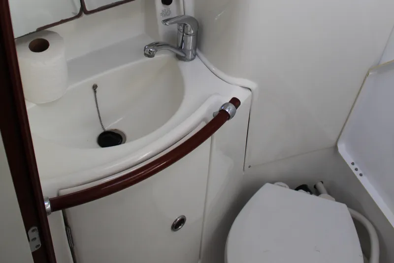 Coyote Yacht Photos Pics Compact bathroom in a 2004 Beneteau Oceanis Clipper 423 yacht, featuring a sink and toilet.