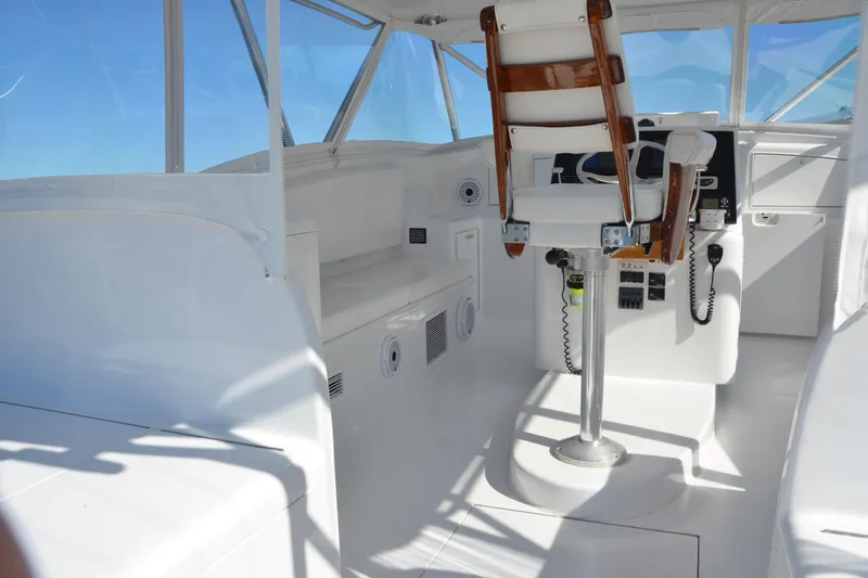 Parlay Yacht Photos Pics 2006 Custom Carolina Heritage Express boat interior with captain's chair and control panel.