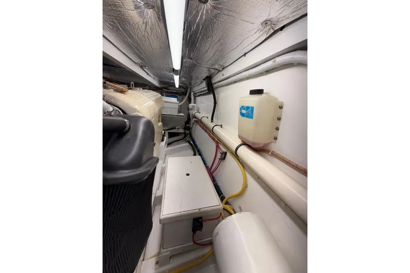 Parlay Yacht Photos Pics Engine room of 2006 Custom Carolina Heritage Express boat, featuring pipes and equipment.