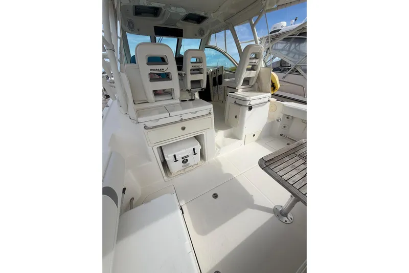  Yacht Photos Pics 2012 Boston Whaler 345 Conquest interior with seating and storage compartments.