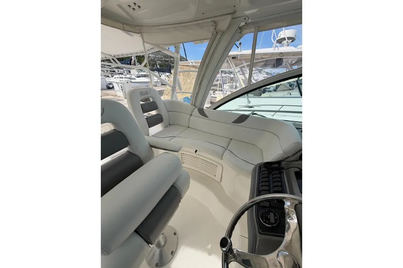  Yacht Photos Pics Interior of 2012 Boston Whaler 345 Conquest boat, featuring plush seating and helm controls.