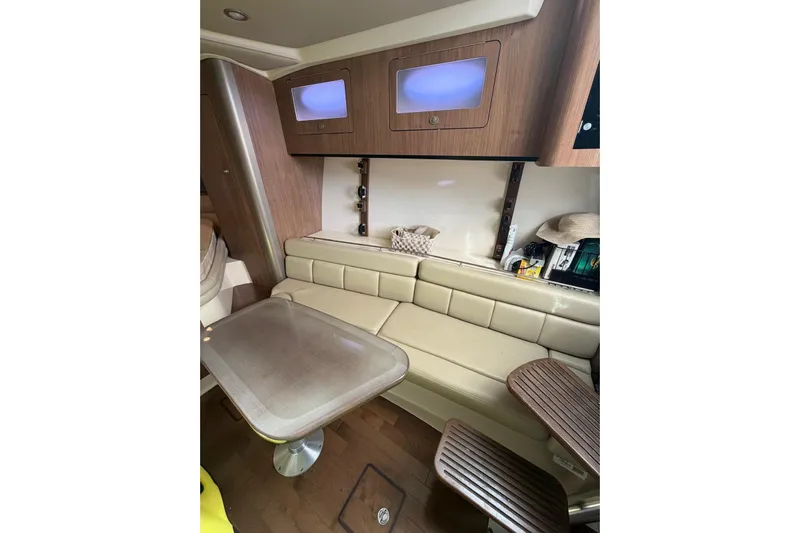  Yacht Photos Pics Interior of 2012 Boston Whaler 345 Conquest, featuring a cozy seating area and table.