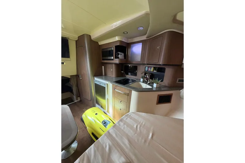  Yacht Photos Pics Interior of 2012 Boston Whaler 345 Conquest, featuring a compact kitchen area.