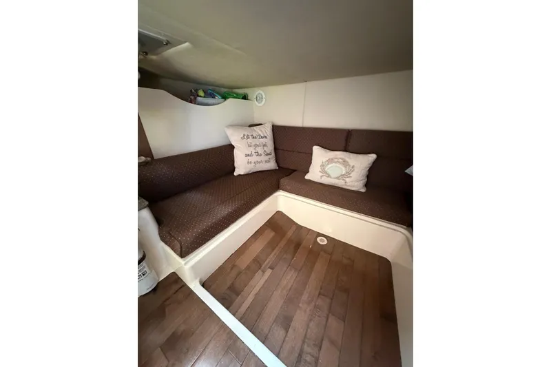  Yacht Photos Pics 2012 Boston Whaler 345 Conquest cabin interior with cozy seating and decorative pillows.