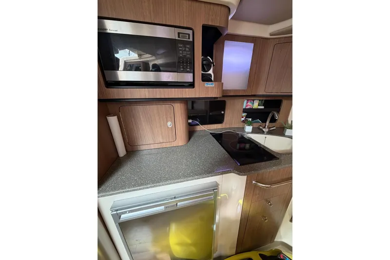  Yacht Photos Pics 2012 Boston Whaler 345 Conquest kitchen with microwave, stove, and sink.
