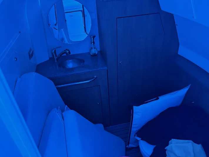  Yacht Photos Pics Interior cabin of 2016 Boston Whaler 350 Outrage with sink and seating area.