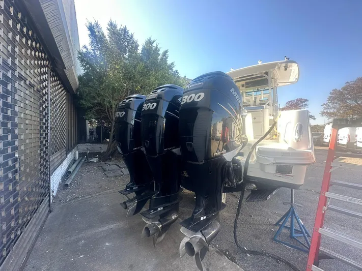  Yacht Photos Pics 2016 Boston Whaler 350 Outrage with triple 300 horsepower engines, docked outdoors.