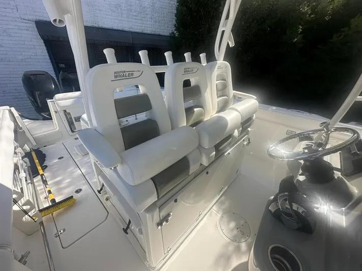  Yacht Photos Pics 2016 Boston Whaler 350 Outrage boat interior with white seating and steering wheel.