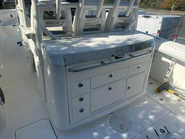  Yacht Photos Pics 2016 Boston Whaler 350 Outrage boat interior with storage compartments and seating.