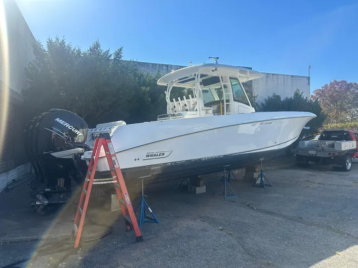  Yacht Photos Pics 2016 Boston Whaler 350 Outrage boat on stands, with ladder and Mercury engines.