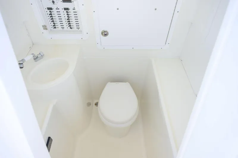  Yacht Photos Pics 2016 SeaVee 390Z boat bathroom with toilet, sink, and control panel.