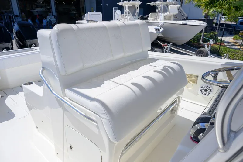  Yacht Photos Pics 2016 SeaVee 390Z boat with white cushioned seating and steering wheel.