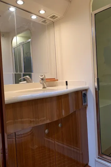  Yacht Photos Pics Bathroom interior of a 2007 Viking 52 yacht with wooden cabinetry and glass shower.