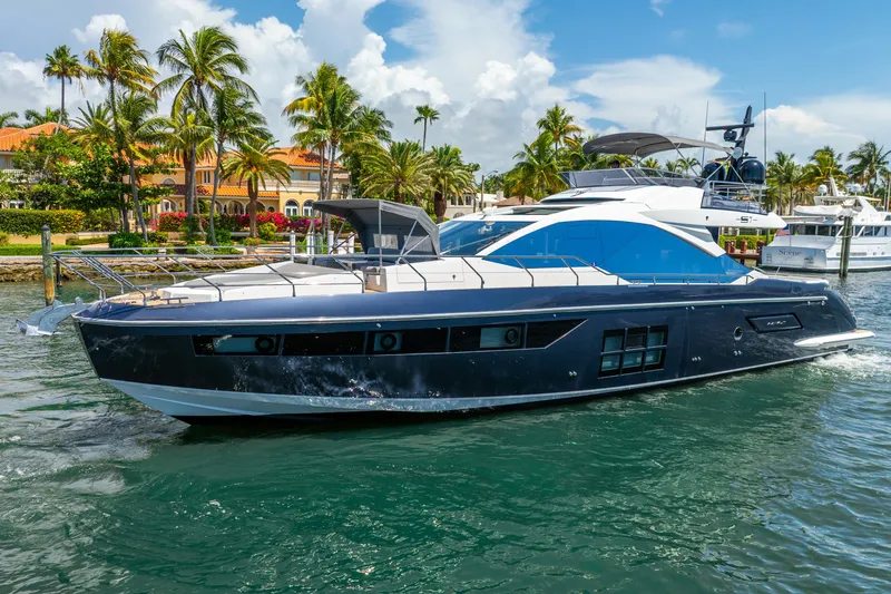  Yacht Photos Pics 2019 Azimut S7 yacht cruising in tropical waters with palm trees in the background.