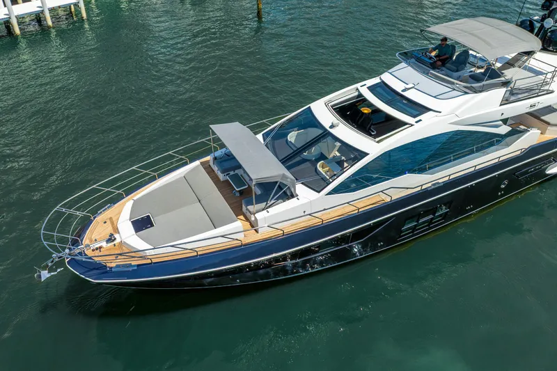  Yacht Photos Pics 2019 Azimut S7 yacht cruising on clear blue water, showcasing sleek design and luxury features.