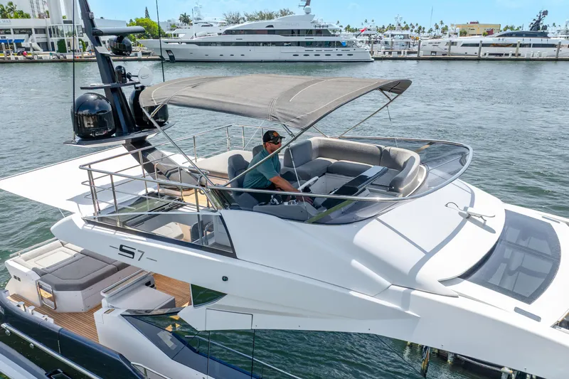 Yacht Photos Pics 2019 Azimut S7 yacht with flybridge, docked in a marina, featuring sleek design and luxury seating.