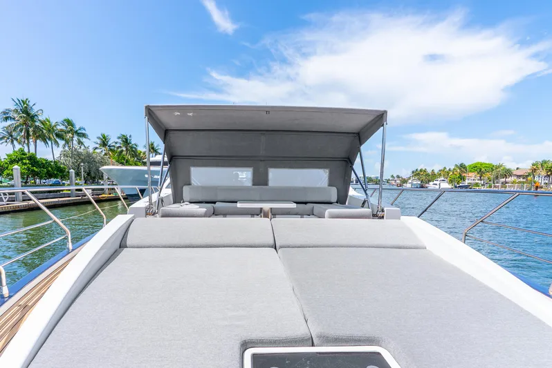  Yacht Photos Pics 2019 Azimut S7 yacht with sunbathing deck, docked by palm trees and clear blue sky.