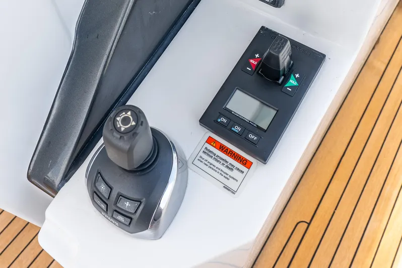  Yacht Photos Pics Control panel of a 2019 Azimut S7 yacht with joystick and display on teak deck.