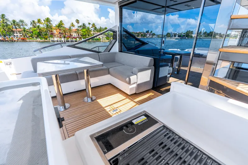  Yacht Photos Pics 2019 Azimut S7 yacht with luxurious deck seating and scenic waterfront view.