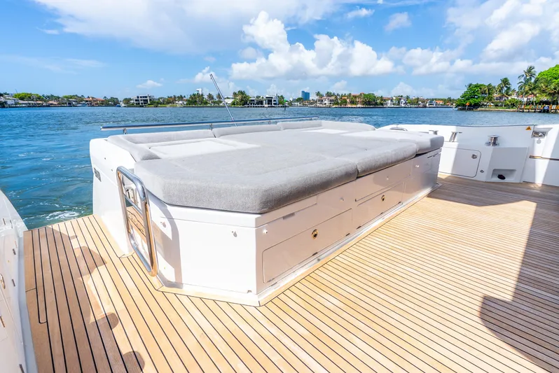  Yacht Photos Pics 2019 Azimut S7 yacht deck with sunbed, overlooking serene waters and blue sky.