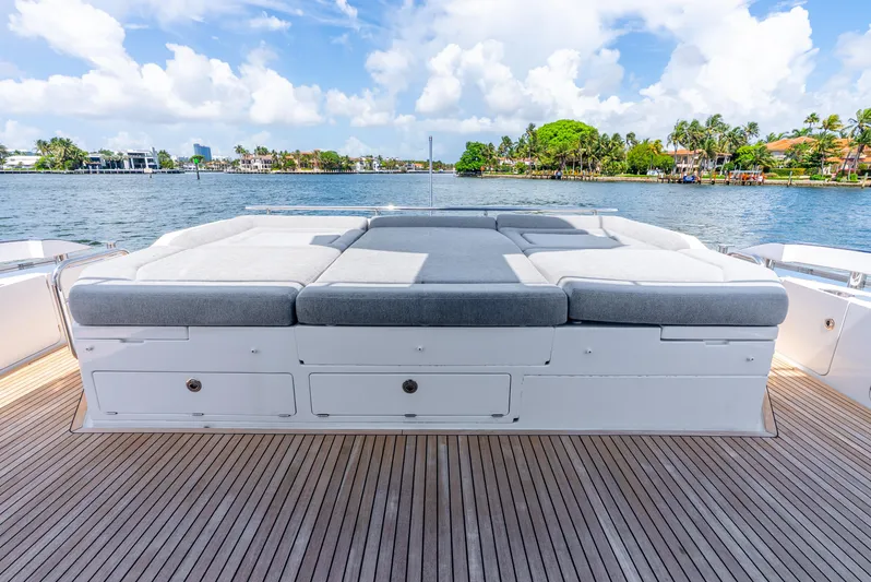  Yacht Photos Pics 2019 Azimut S7 yacht deck with cushioned seating, overlooking serene waterfront scenery.