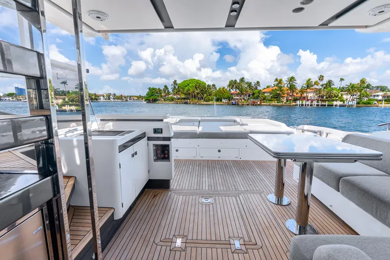  Yacht Photos Pics Luxurious 2019 Azimut S7 yacht deck with seating, table, and scenic waterfront view.