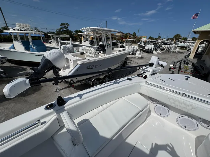 Used Yacht Photos Pics 2024 Contender 28 Tournament boat in a marina, surrounded by other vessels and equipment.