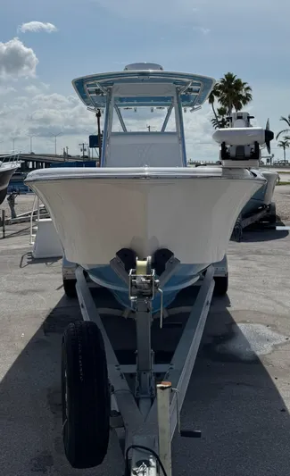 Used Yacht Photos Pics 2024 Contender 28 Tournament boat on trailer, sunny day, marina background.