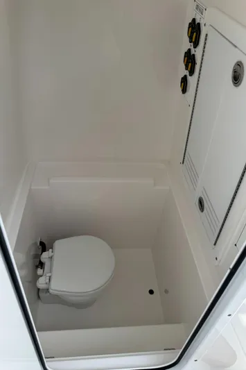 Used Yacht Photos Pics 2024 Contender 28 Tournament boat interior with compact marine toilet.