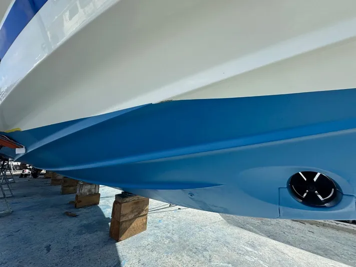 Ain't Settlin! Yacht Photos Pics 2013 Prestige 550 Flybridge yacht hull on dry dock, showcasing blue and white exterior.