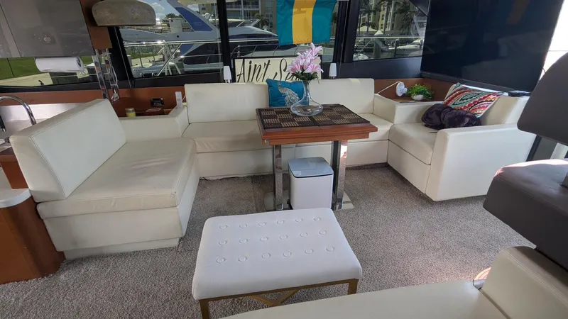 Ain't Settlin! Yacht Photos Pics Luxurious interior of 2013 Prestige 550 Flybridge yacht with white leather seating and elegant decor.