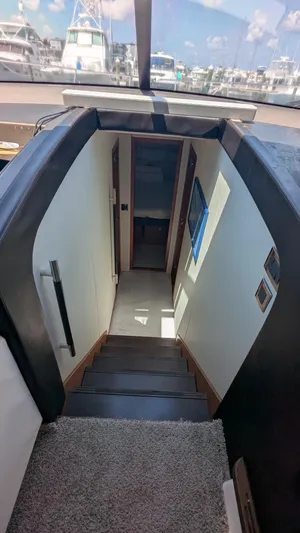 Ain't Settlin! Yacht Photos Pics Stairway inside 2013 Prestige 550 Flybridge yacht, leading to lower deck cabins.