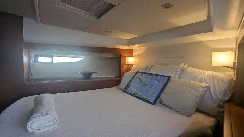 Ain't Settlin! Yacht Photos Pics Luxurious bedroom interior of 2013 Prestige 550 Flybridge yacht with cozy bedding.
