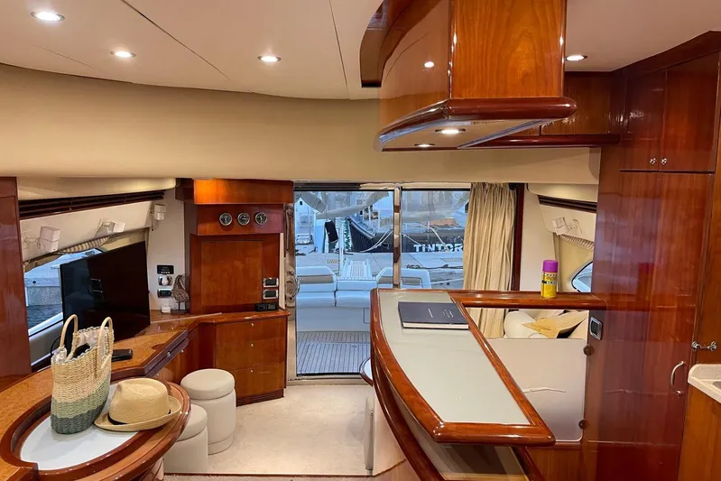  Yacht Photos Pics Luxurious interior of 2007 Aicon 56 yacht with elegant wood finishes and modern amenities.