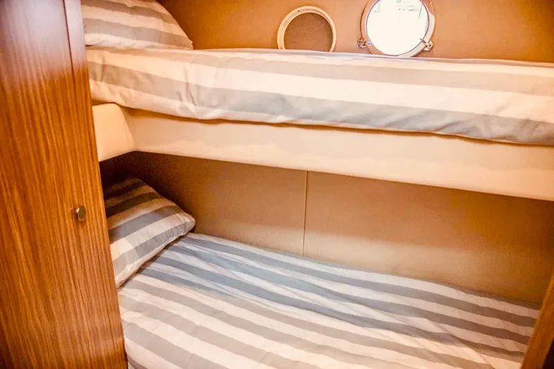  Yacht Photos Pics Bunk beds in 2018 Azimut Magellano 53 yacht cabin with striped bedding.