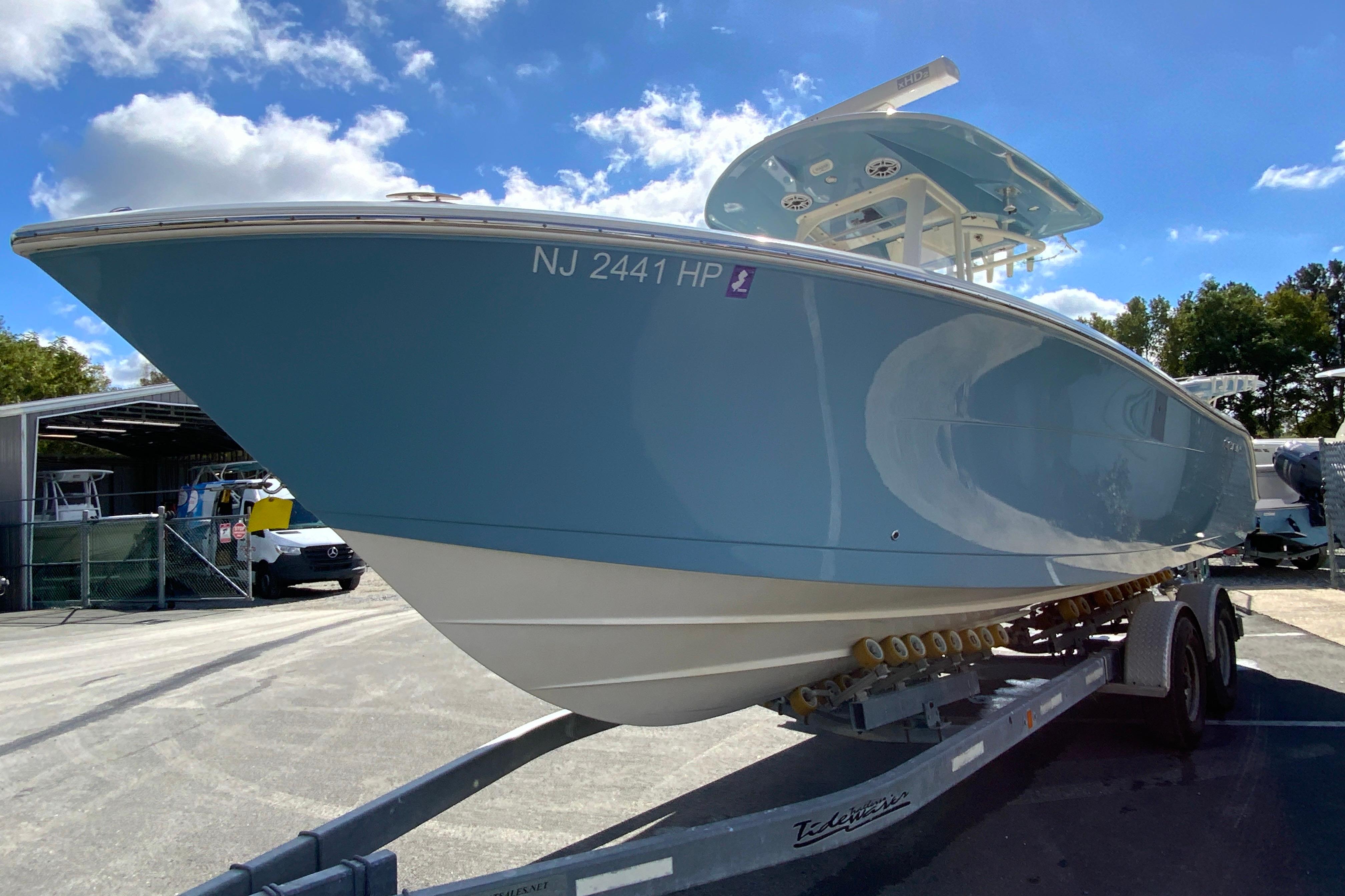 2021 Cobia 280 Center Console boat on trailer under blue sky.