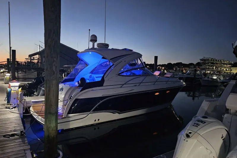 Sea Wolf Yacht Photos Pics 2010 Formula 34 Performance Cruiser docked at sunset with blue interior lighting.