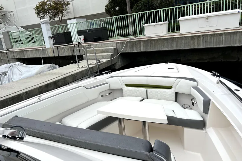  Yacht Photos Pics 2019 Tiara Sport 34 LS boat with white seating and table, docked at marina.
