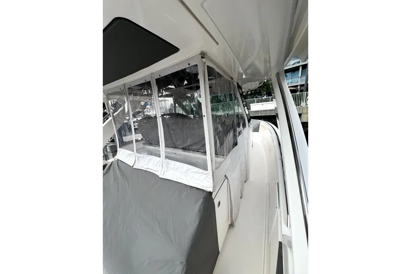  Yacht Photos Pics 2019 Tiara Sport 34 LS boat with covered seating and clear enclosures.
