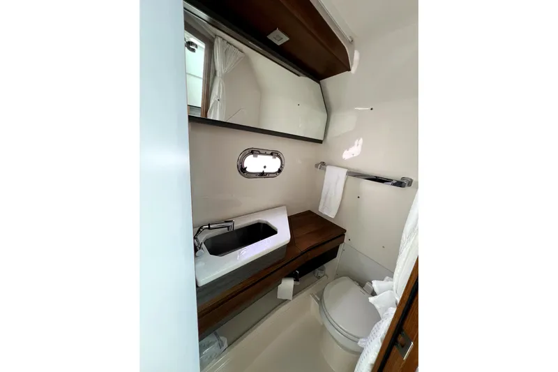  Yacht Photos Pics 2019 Tiara Sport 34 LS boat bathroom with sink, mirror, and toilet.