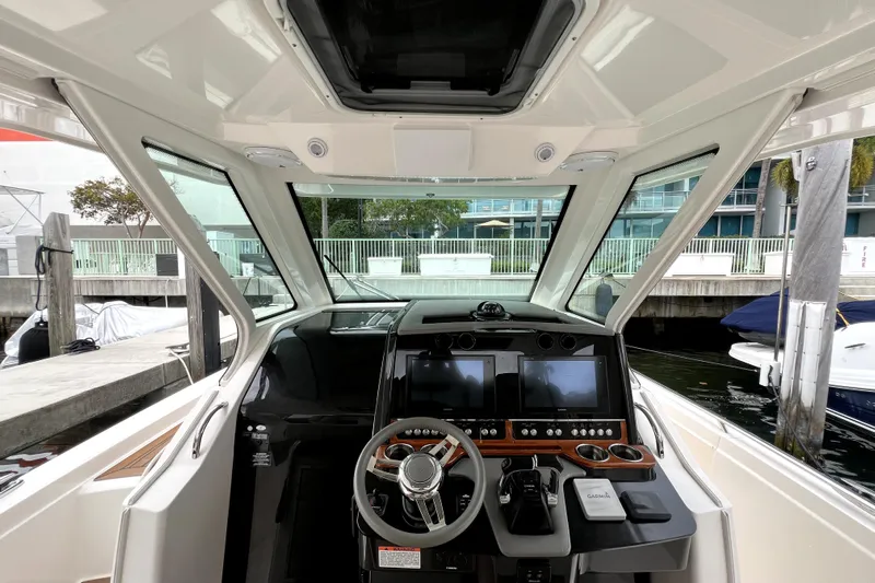  Yacht Photos Pics 2019 Tiara Sport 34 LS boat cockpit with modern navigation controls and steering wheel.