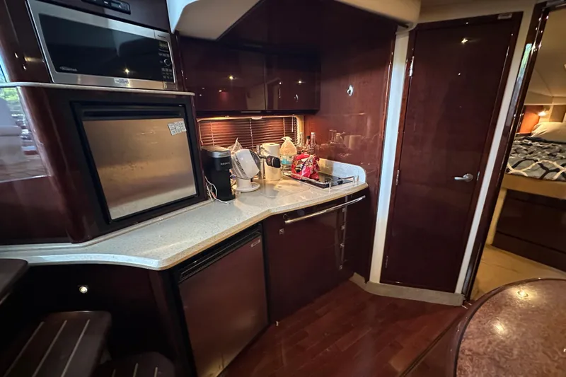  Yacht Photos Pics Interior of 2010 Sea Ray 390 Sundancer yacht kitchen with modern appliances and wood finish.