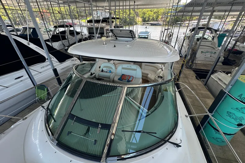  Yacht Photos Pics 2010 Sea Ray 390 Sundancer docked in a marina, showcasing sleek design and spacious interior.