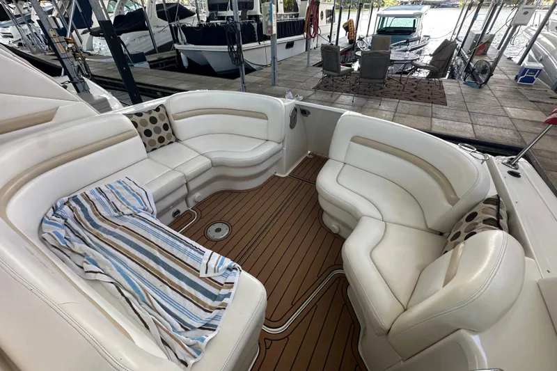  Yacht Photos Pics Luxurious 2010 Sea Ray 390 Sundancer boat interior with white seating and wooden deck.