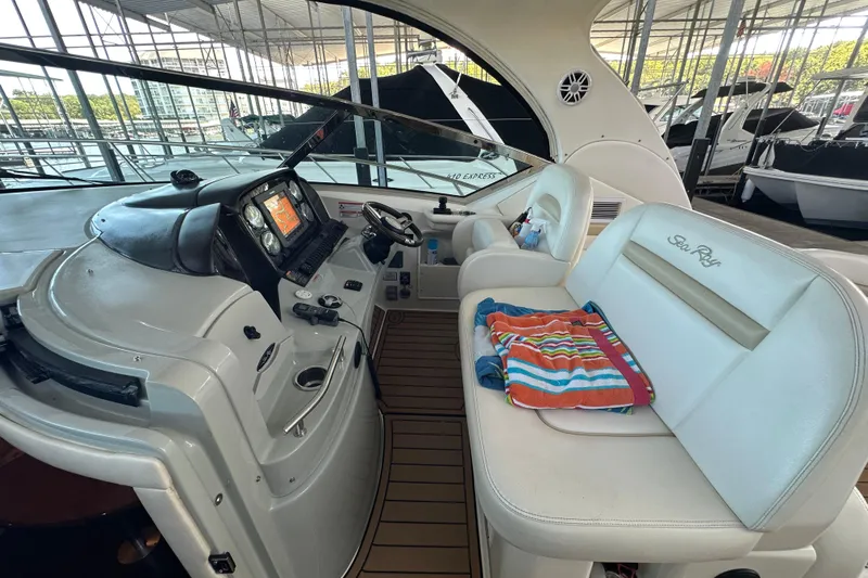  Yacht Photos Pics 2010 Sea Ray 390 Sundancer cockpit with helm, navigation system, and seating area.