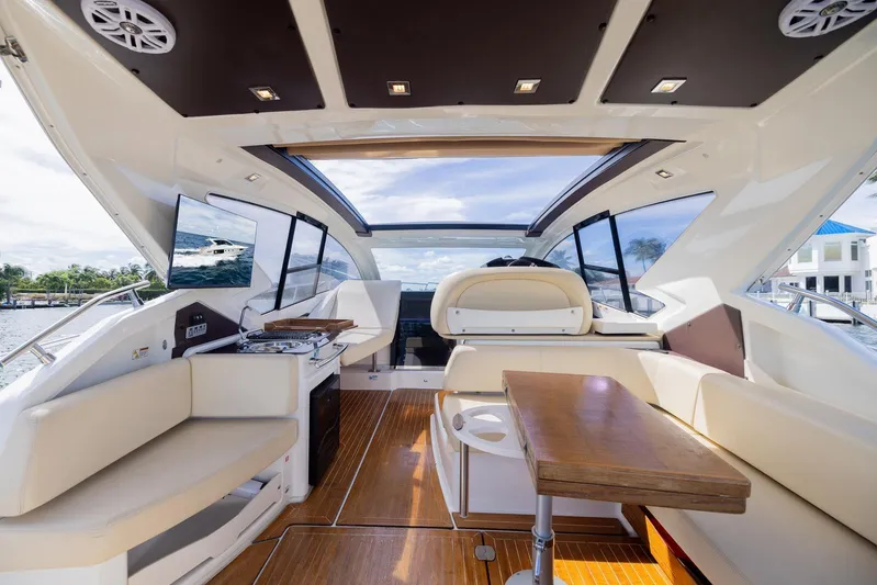 She's Royal Yacht Photos Pics Luxurious interior of 2014 Cranchi M 44 HT yacht with elegant seating and wooden table.